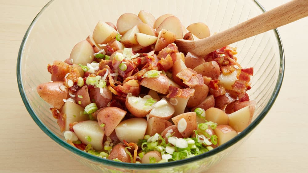 Mix potatoes, bacon, and green onions.  