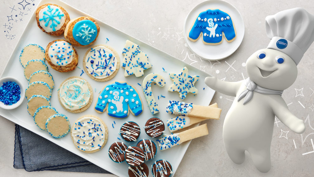 The Pillsbury Doughboy with a tray of Christmas cookies