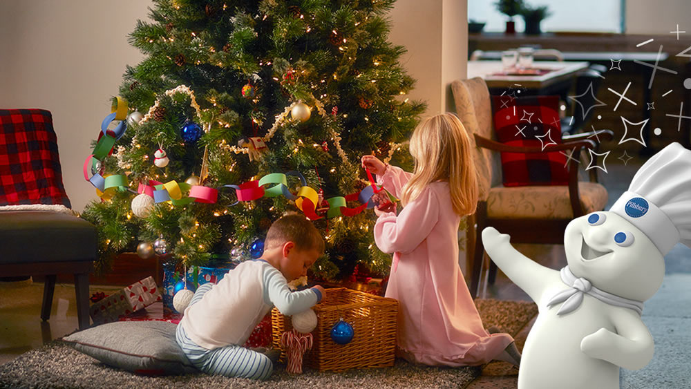 Kids decorating the bottom of a Christmas Tree