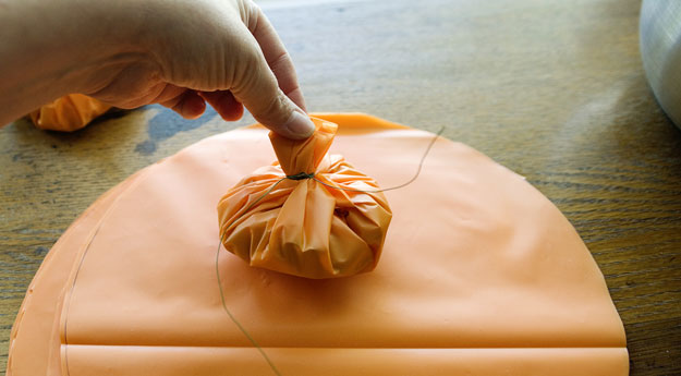 party mix wrapped up into pumpkin shape and sealed with twisted wire