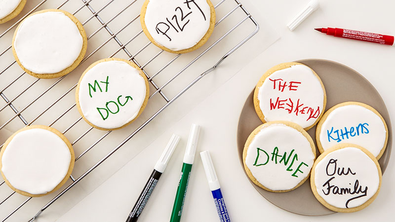 Cookies with white frosting, edible ink pens
